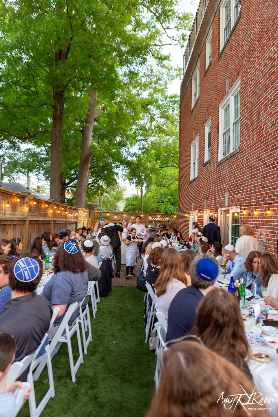 A long graduation dinner table stretching down the garden