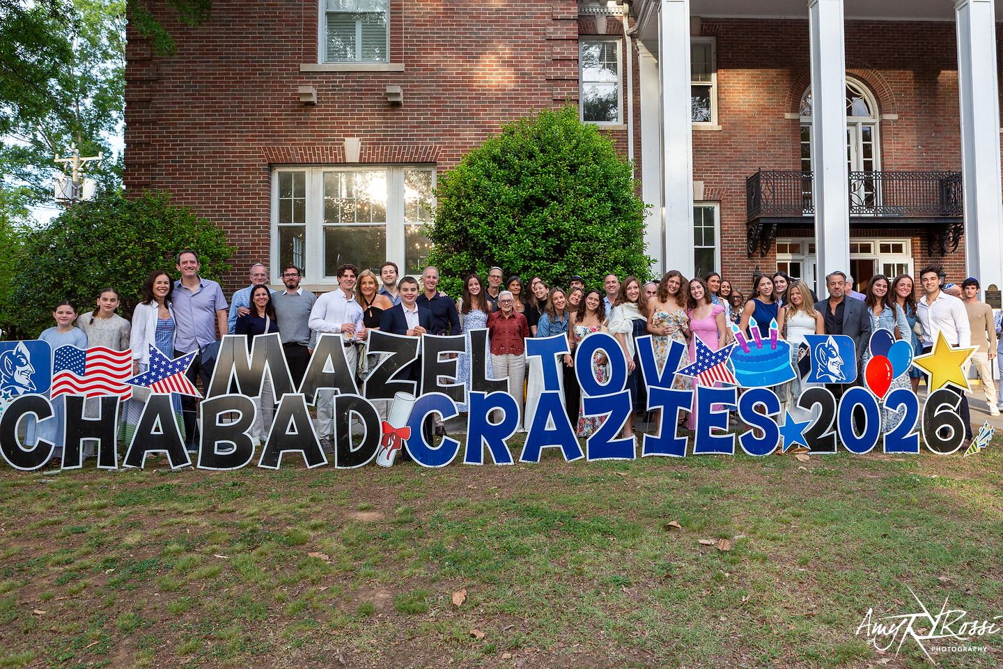 The graduating class gathered behind a Mazel Tov Chabad Crazies 2026 sign