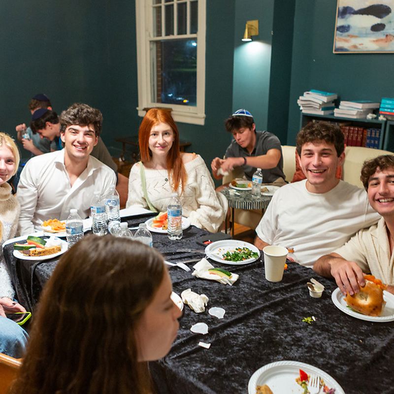 Students around the break-fast table in the green room